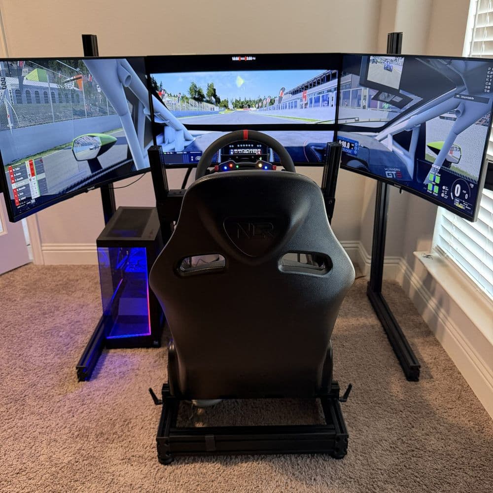 Triple-screen static rig running a race