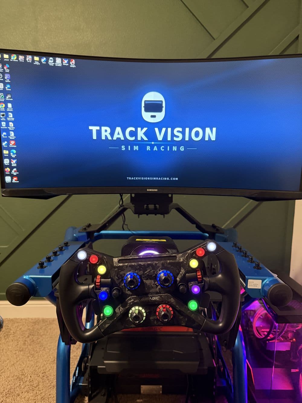 Formula wheel on the blue tubular rig in front of a Track Vision screen