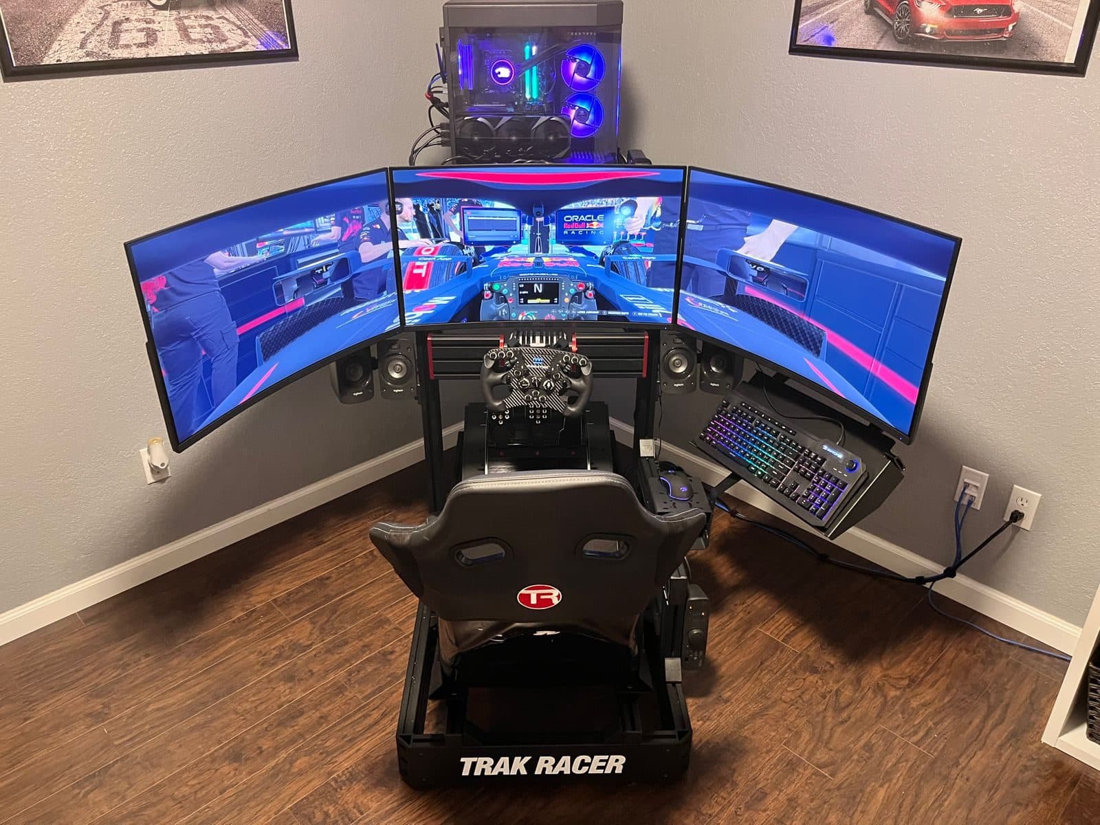 Three curved monitors angled in around a sim racing cockpit