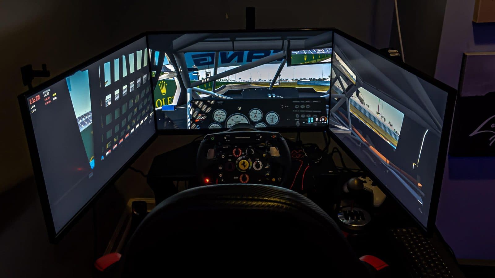 Driver's-eye view of a triple-monitor sim rig with the side screens angled in