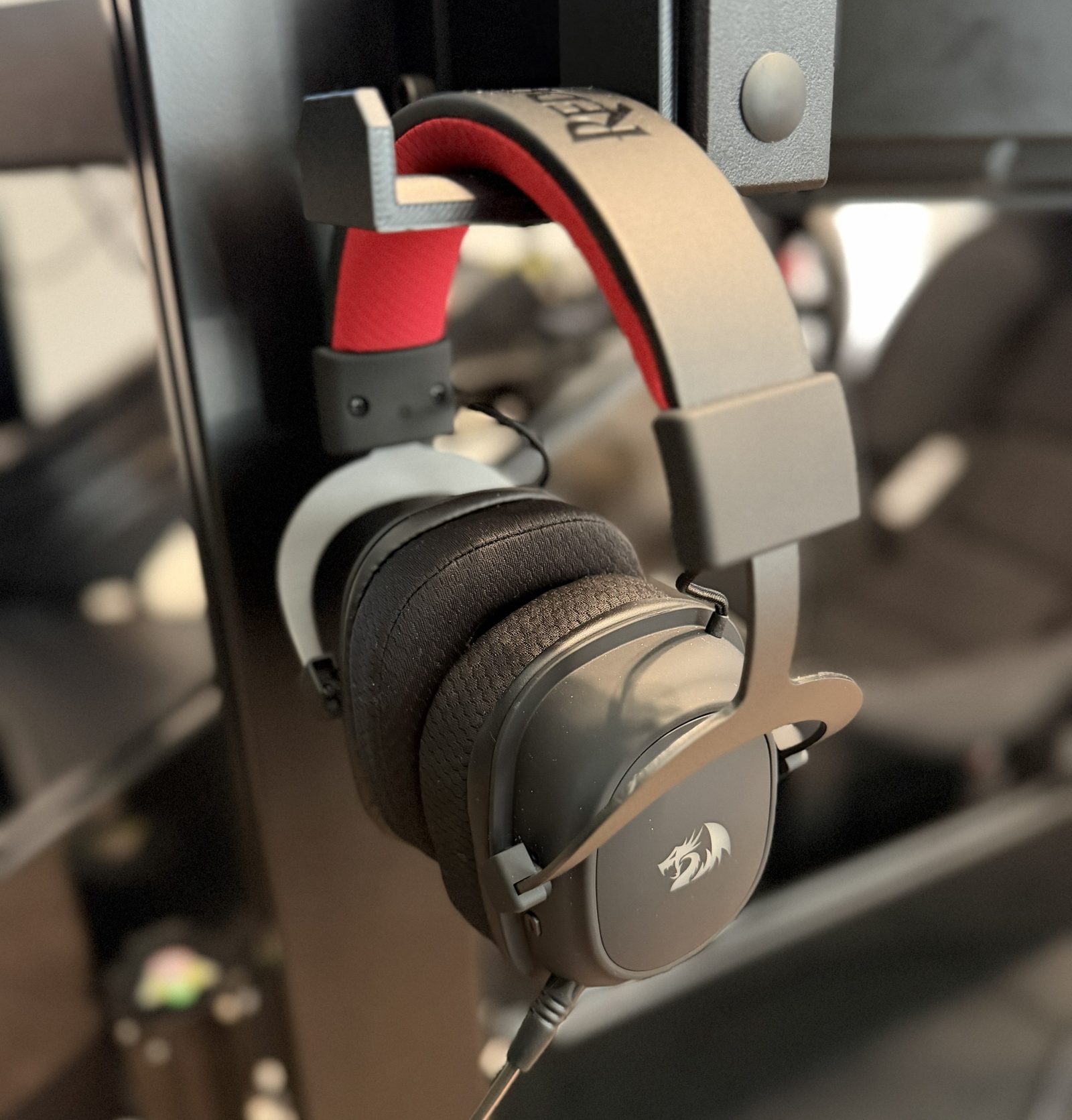 Gaming headset hanging on a mount attached to the simulator