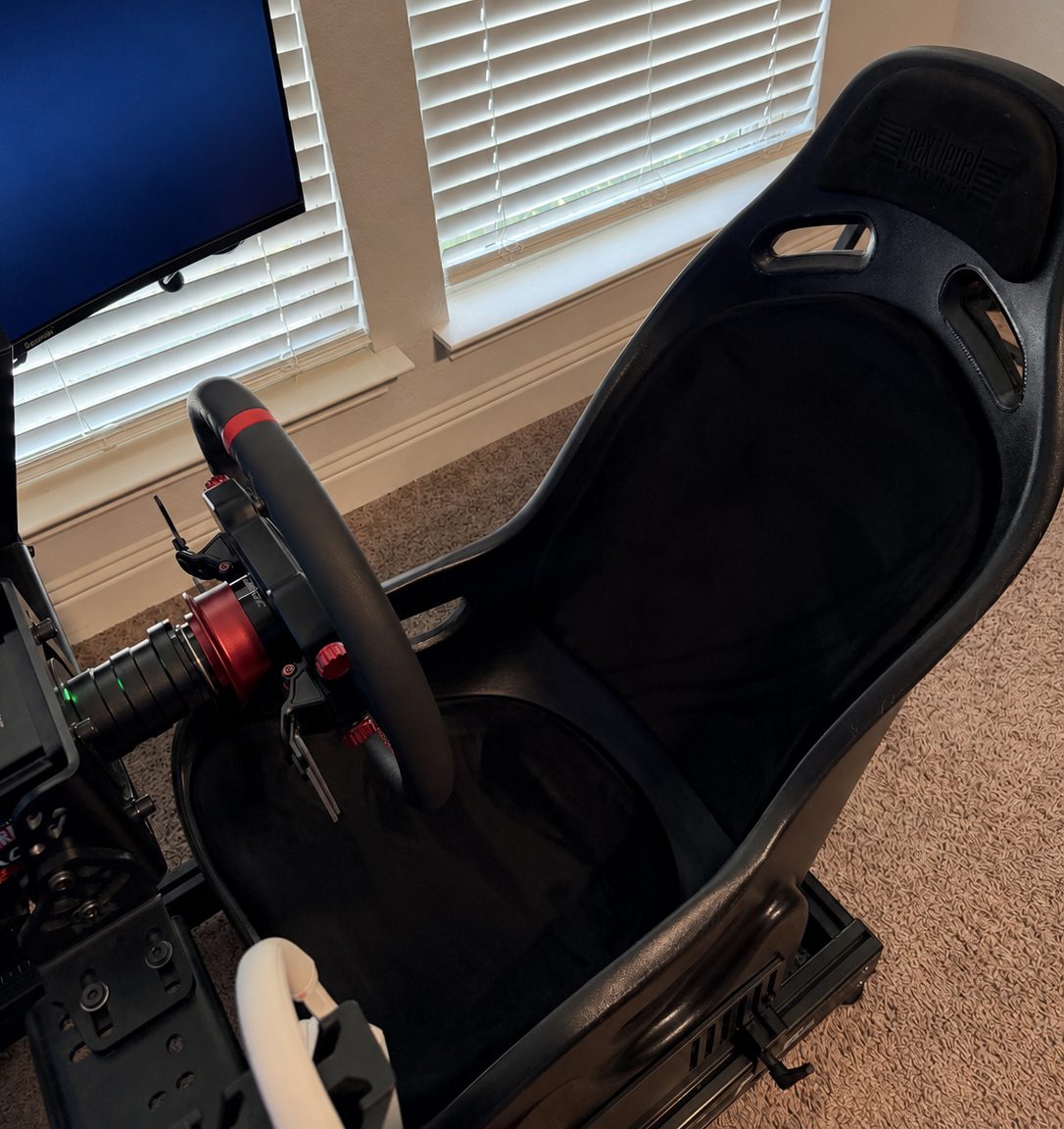 Next Level Racing seat with wheel mounted in front