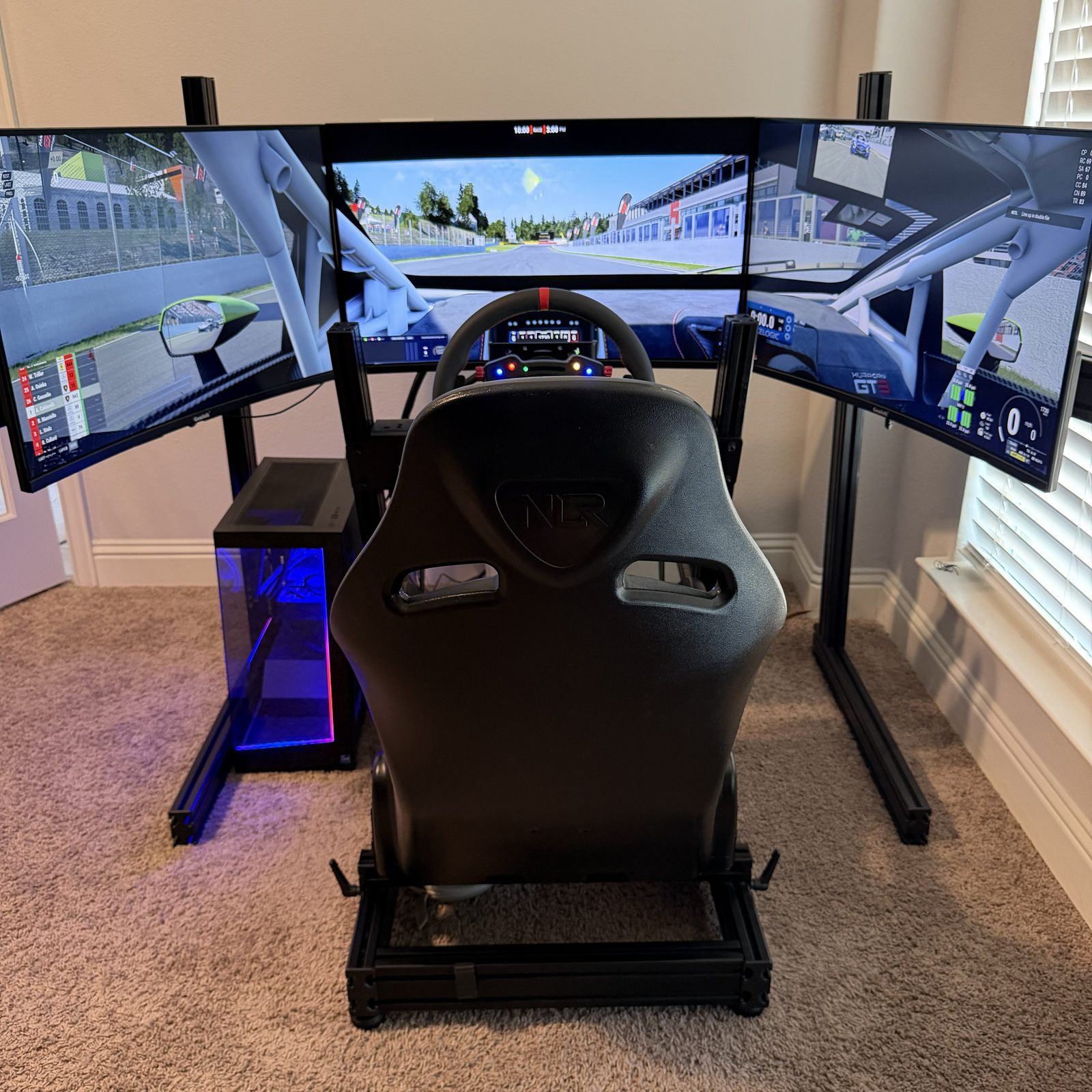 Triple-screen sim rig running a race across all three displays