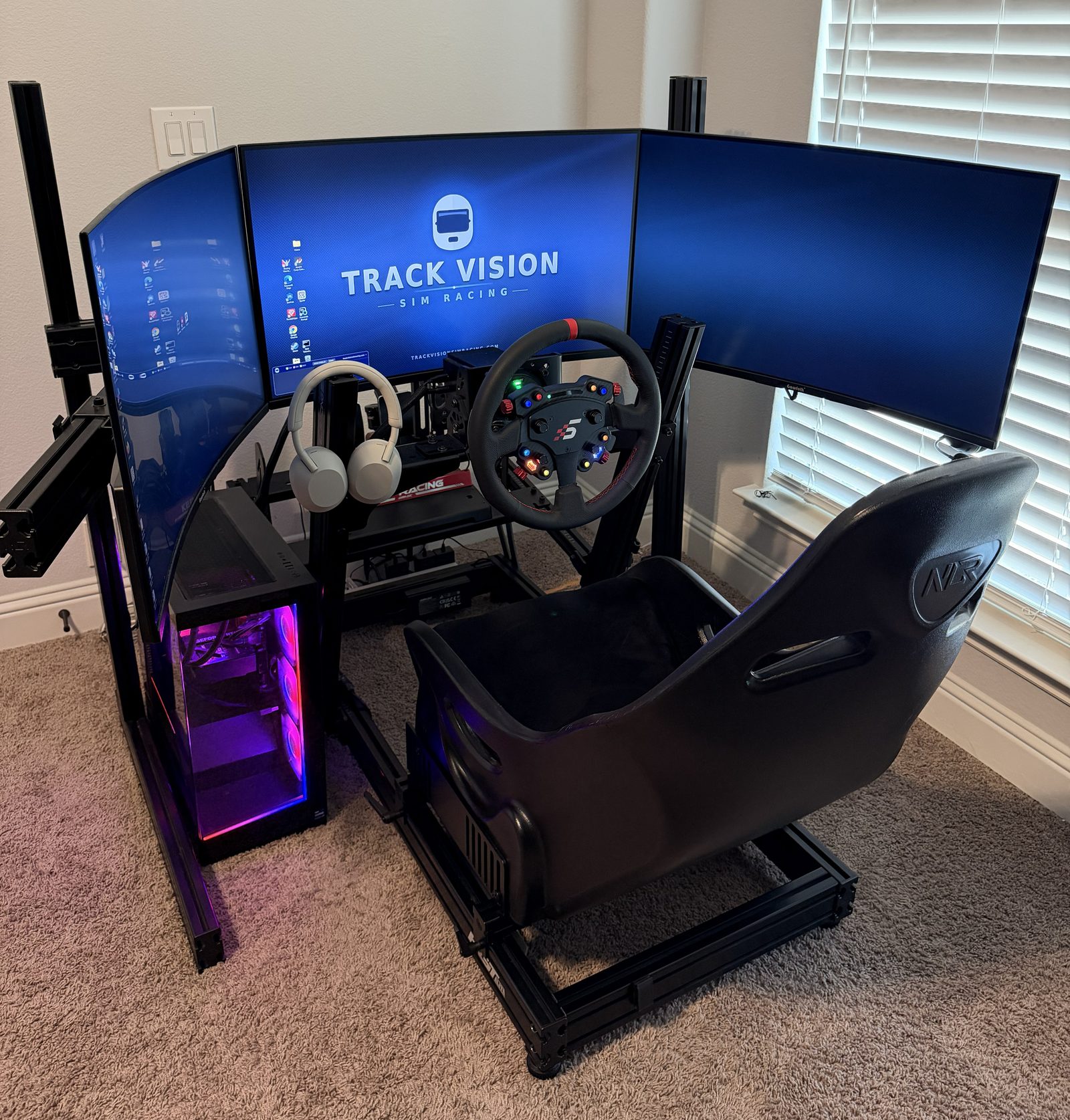 Triple-screen sim racing rig with racing seat and RGB PC