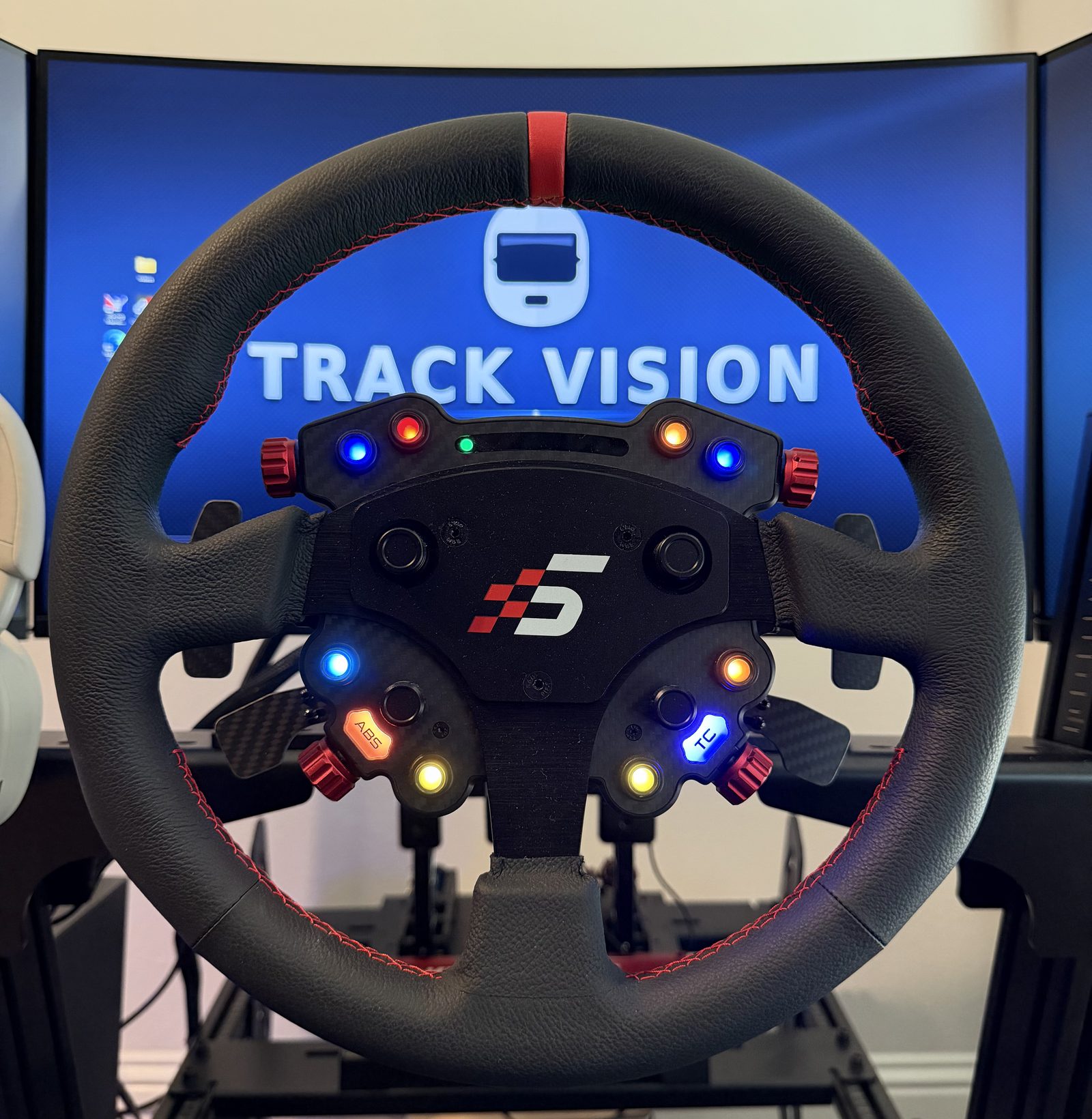 Round sim racing wheel on a direct-drive base